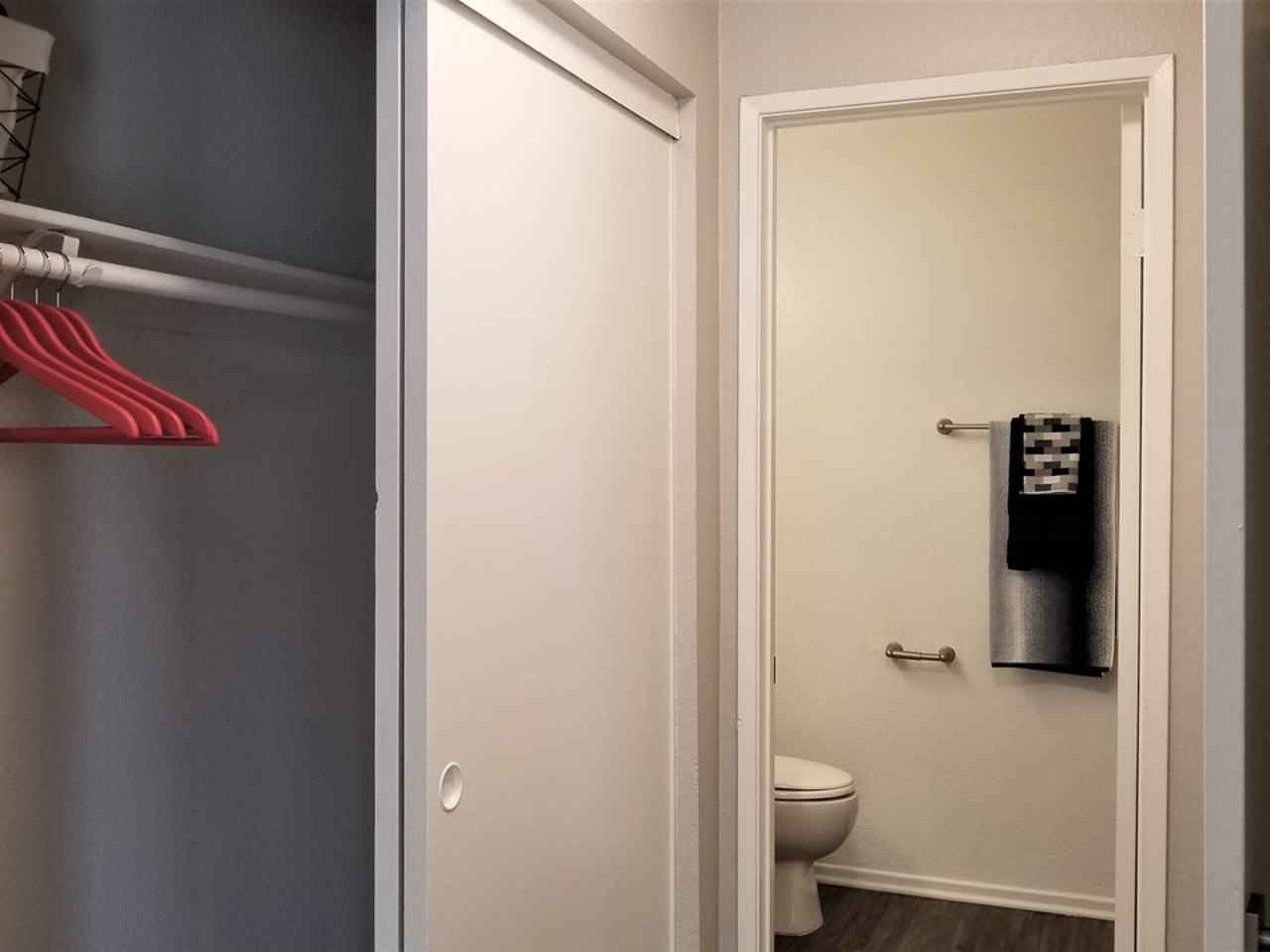 spacious bedroom closet and bathroom entrance