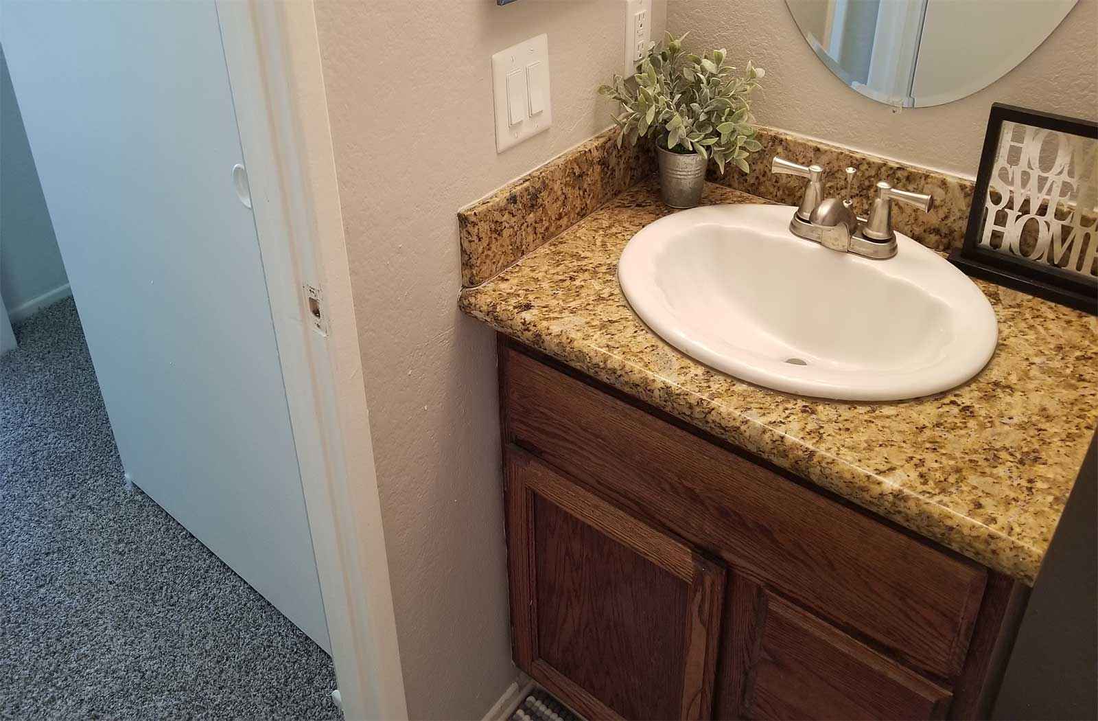 granite style counter vanity and sink