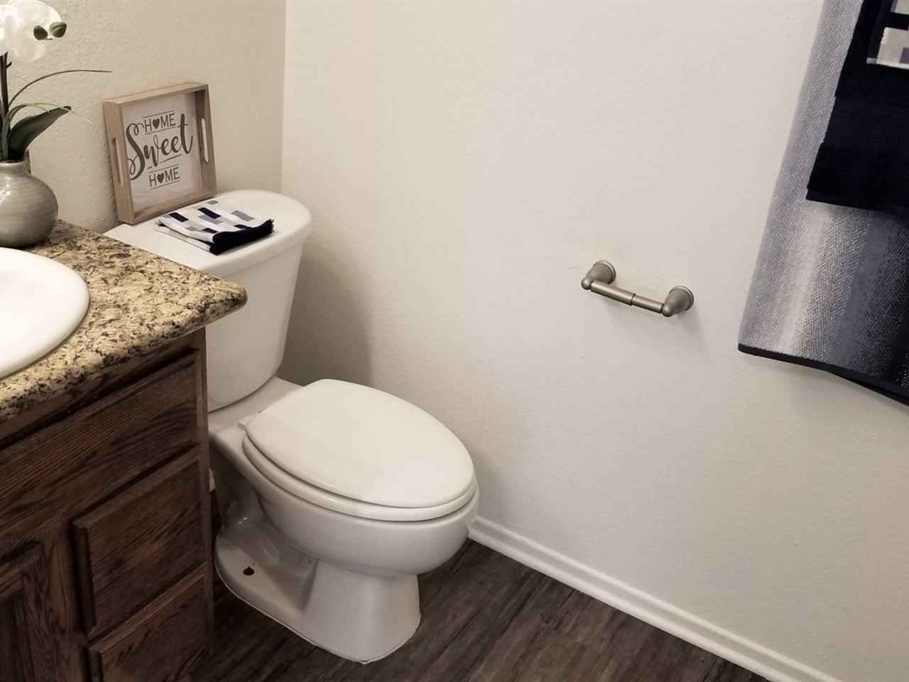 updated bathroom with wood style flooring